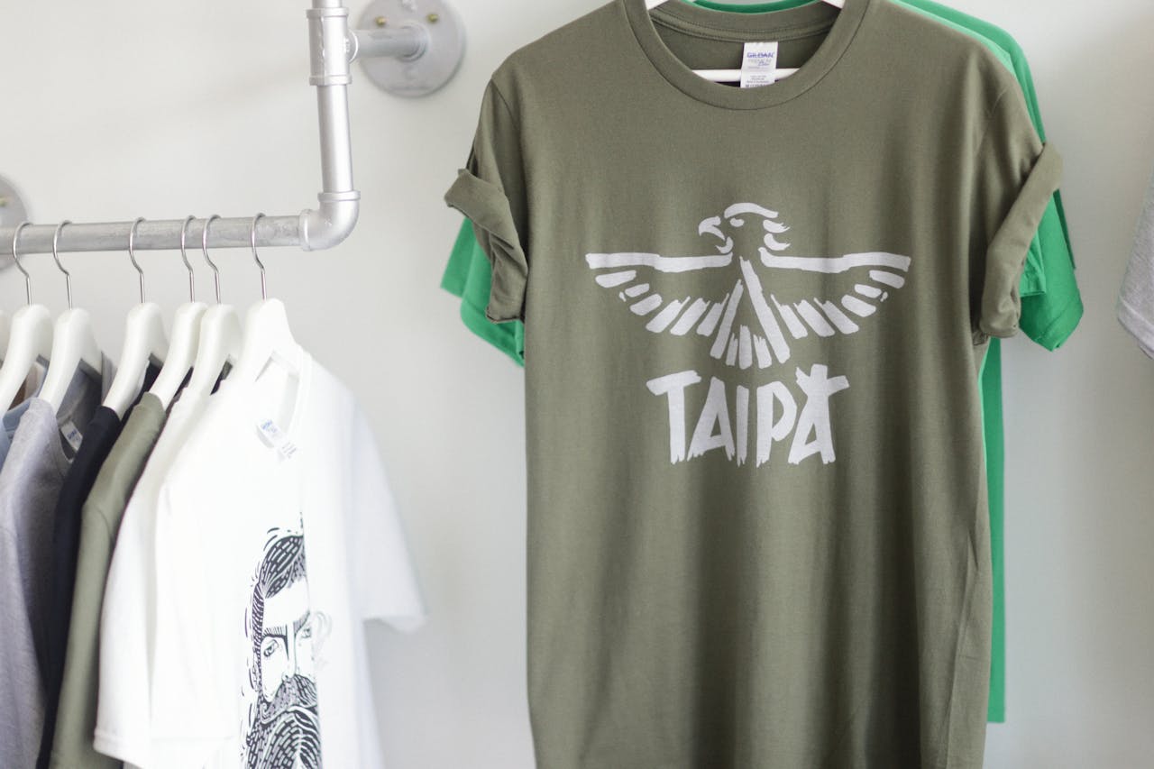 A row of fashionable T-shirts hanging stylishly in a bright retail space.