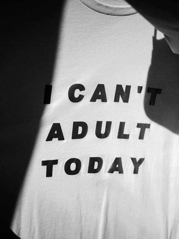 Black and white t-shirt with text "I Can't Adult Today" in a minimalist style.